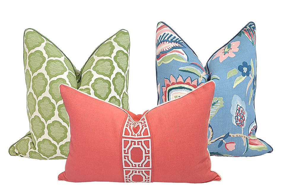 Three pillows with various patterns in corals, pinks, blues, and greens